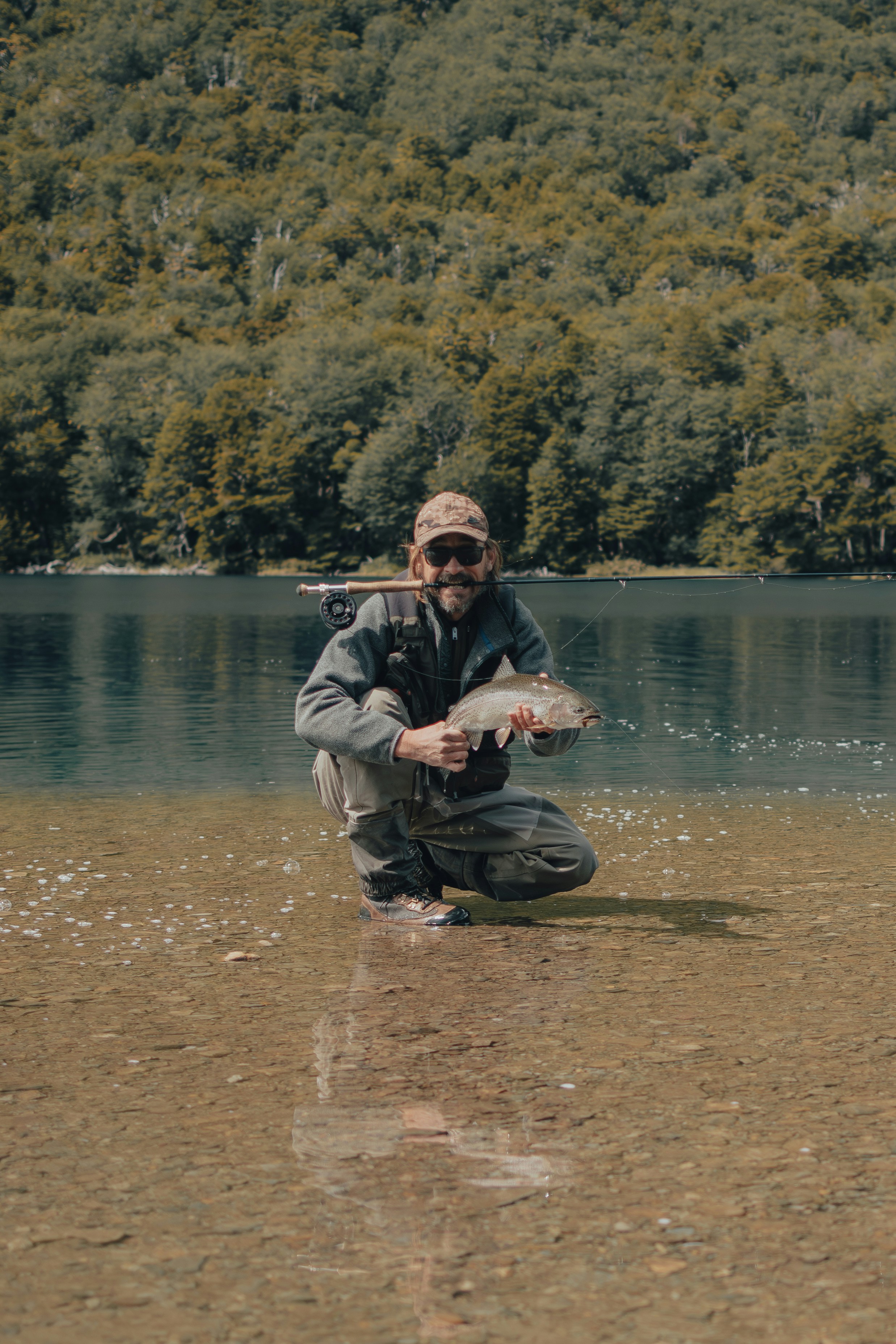 Trophy fish catch at fishing tournament, excited angler, river background Peru